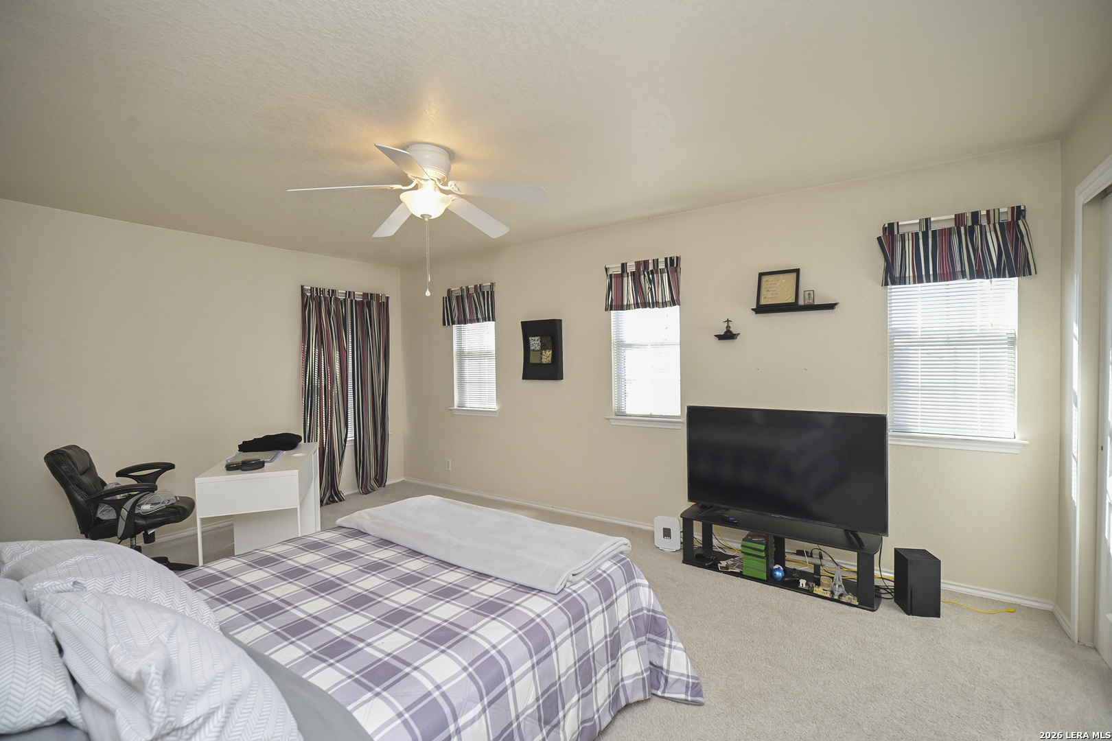 7207 Avery Road Live Oak, TX 78233 - Photo 23 of 42 a bedroom with a bed and a flat screen tv