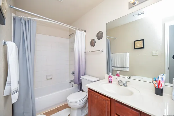 a bathroom with a sink mirror toilet and bathtub