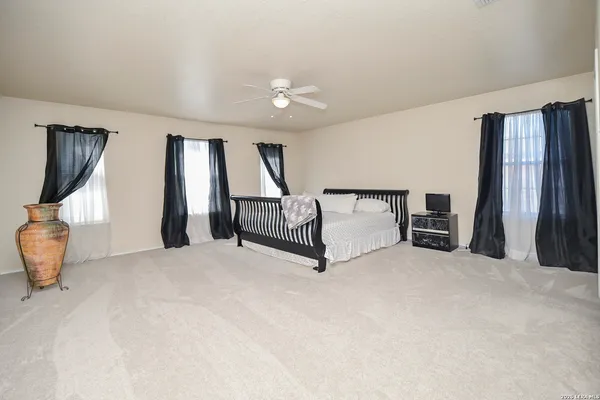 a view of an empty room with window and stairs