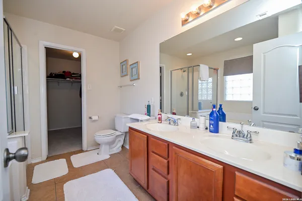 a bathroom with a sink double vanity and a toilet