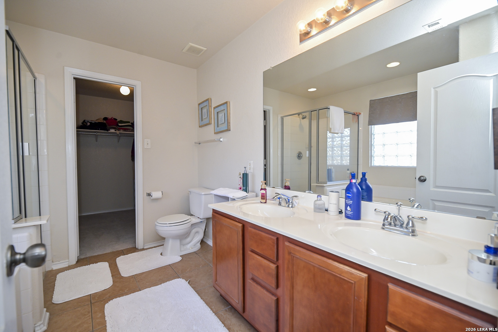 7207 Avery Road Live Oak, TX 78233 - Photo 31 of 42 a bathroom with a sink double vanity and a toilet