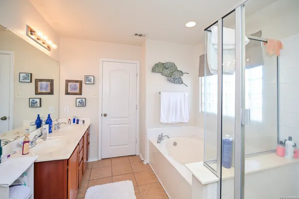 a bathroom with a tub sink and mirror
