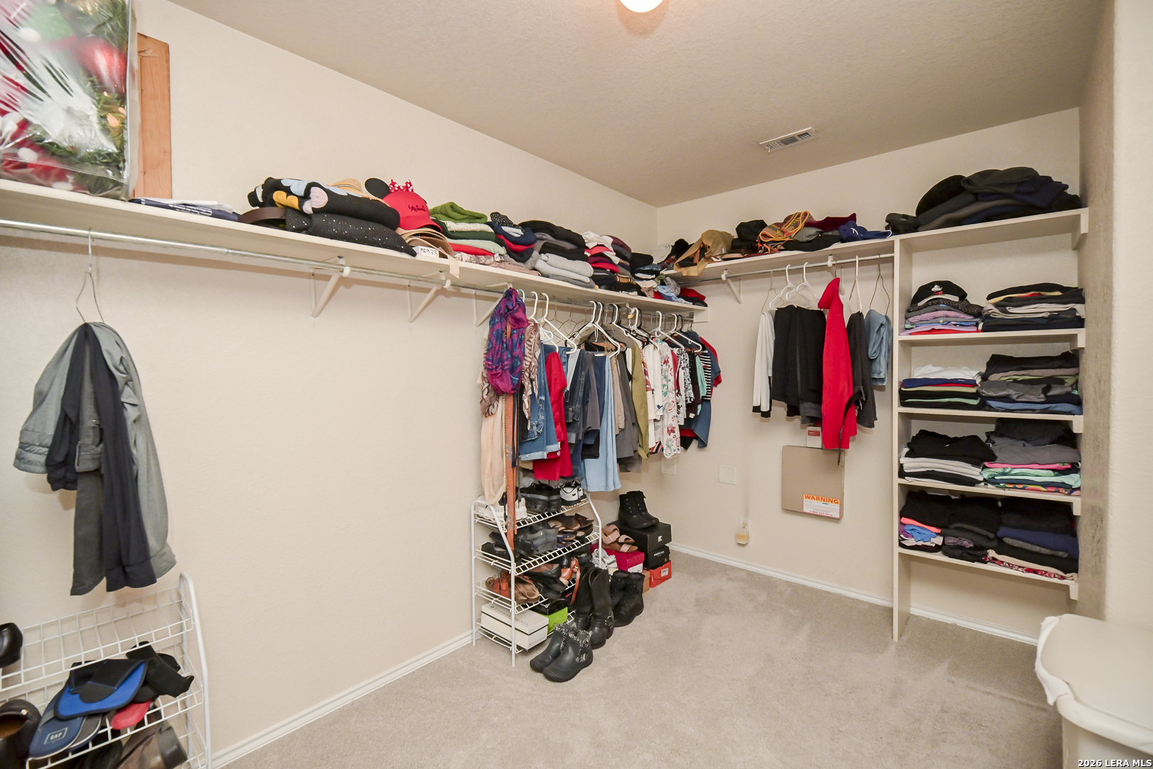 7207 Avery Road Live Oak, TX 78233 - Photo 36 of 42 a view of walk in closet with clothes and shoes