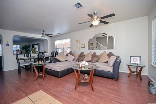 a living room with furniture and wooden floor