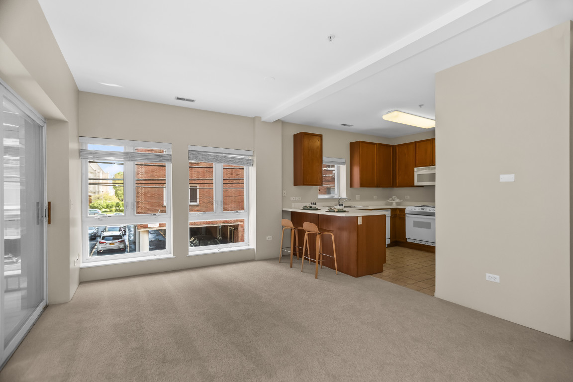 1415 Sherman Avenue, Unit 207 Evanston, IL 60201 - Photo 4 of 25 a large living room with a large window and a fireplace