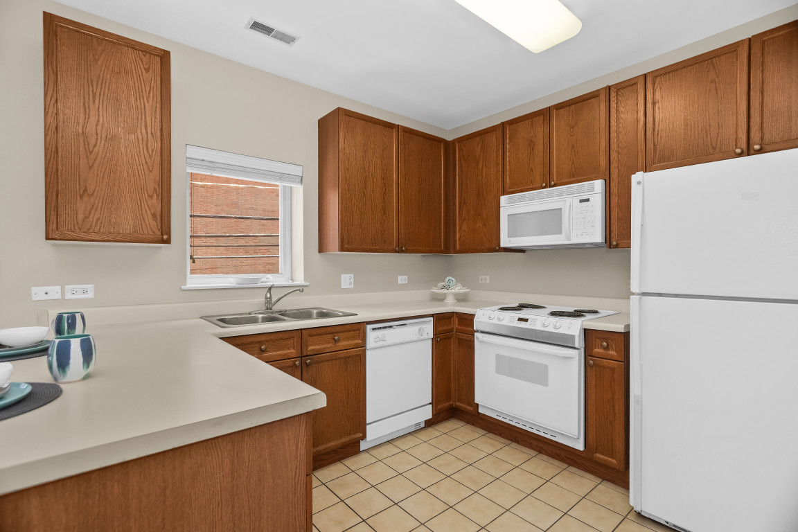1415 Sherman Avenue, Unit 207 Evanston, IL 60201 - Photo 7 of 25 a kitchen with a sink a stove and cabinets