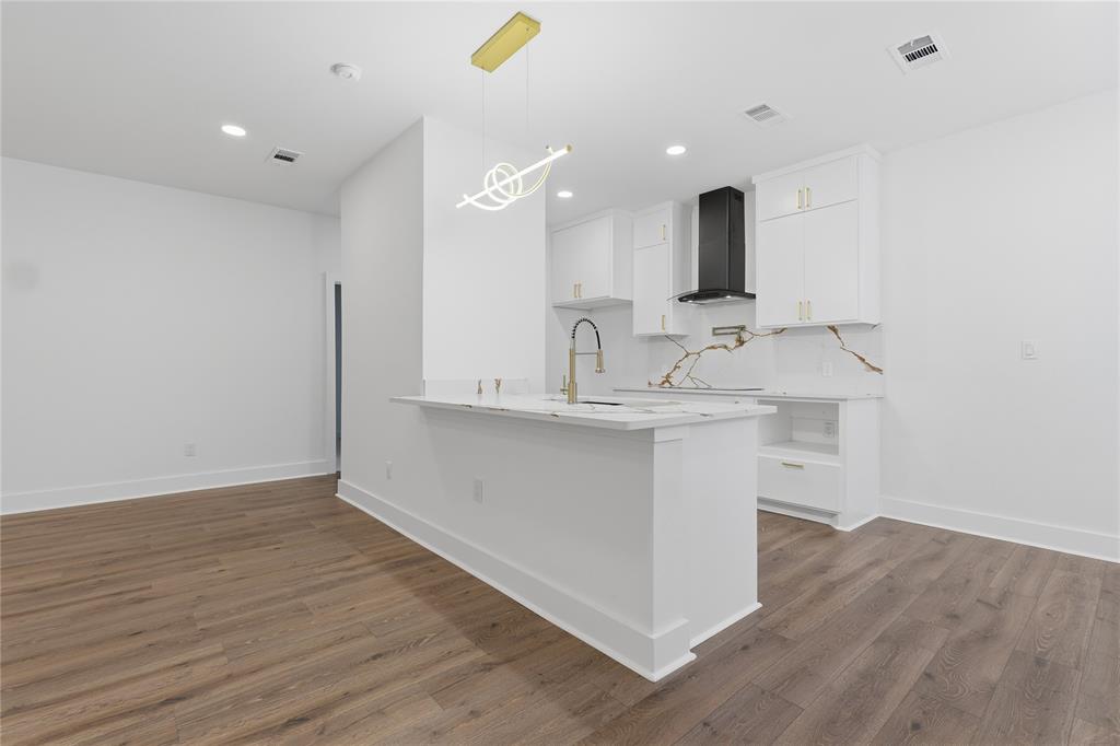 130 Cedar Elm Road Trinidad, TX 75163 - Photo 10 of 27 Modern kitchen featuring white cabinetry with gold-finish hardware, a black range hood, and a striking white and gold veined backsplash