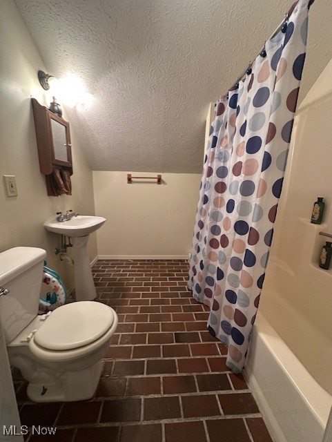 1975 Warner Road Southeast Hubbard, OH 44425 - Photo 16 of 23 Bathroom with a textured ceiling, shower / tub combo with curtain, and brick floors