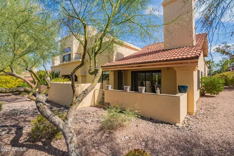 a view of a house with a tree in the background