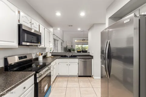 a kitchen with a sink stainless steel appliances and cabinets