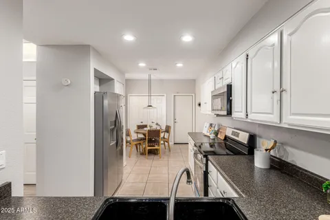 a kitchen with stainless steel appliances granite countertop a refrigerator and a sink