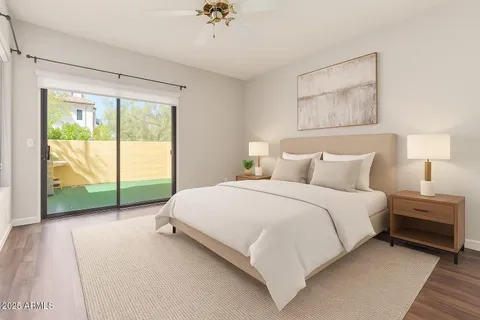 a bedroom with a bed and a large window