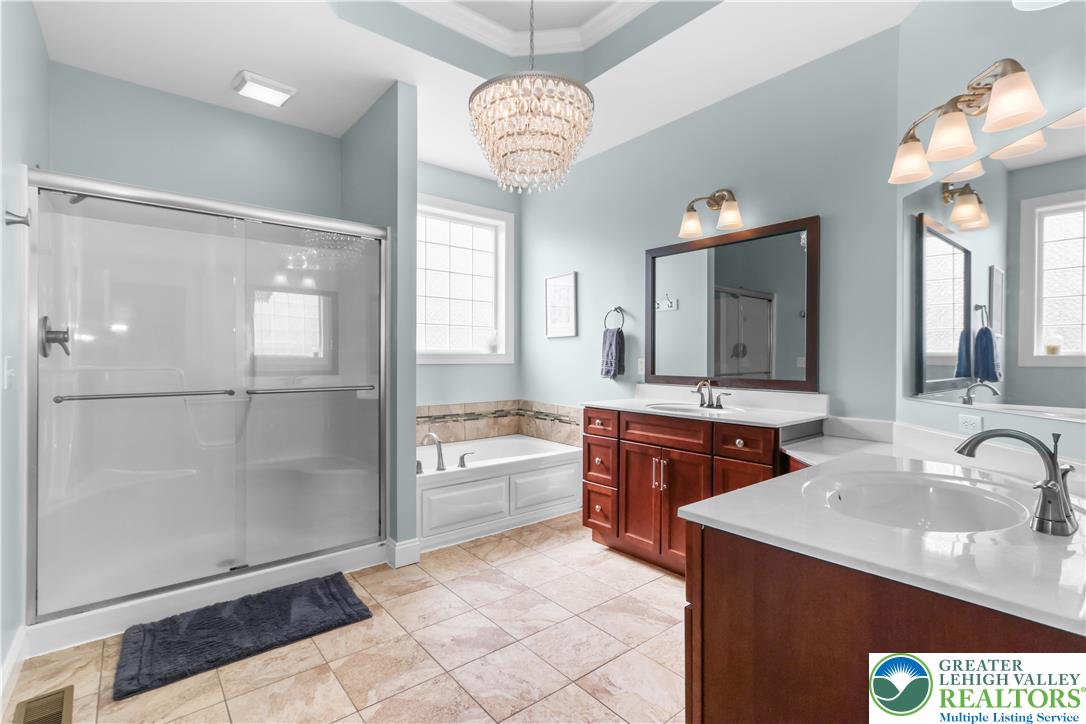 113 Ashview Court Nazareth, PA 18064 - Photo 26 of 41 a spacious bathroom with a granite countertop sink a mirror and a shower