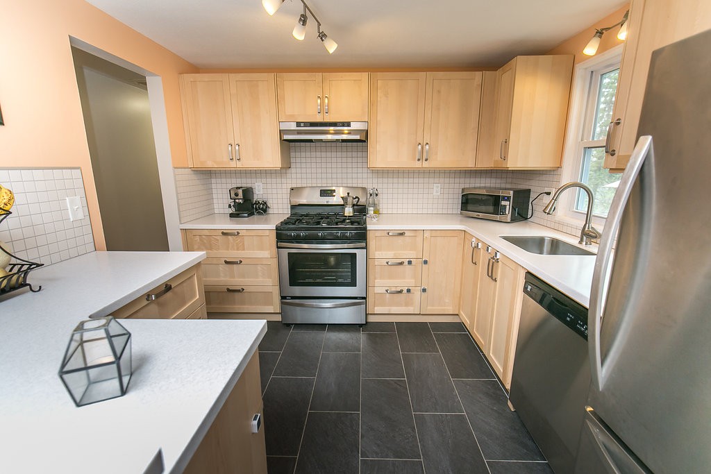 84 Bemis Road Holyoke, MA 01040 - Photo 12 of 30 a kitchen with stainless steel appliances a stove sink and cabinets