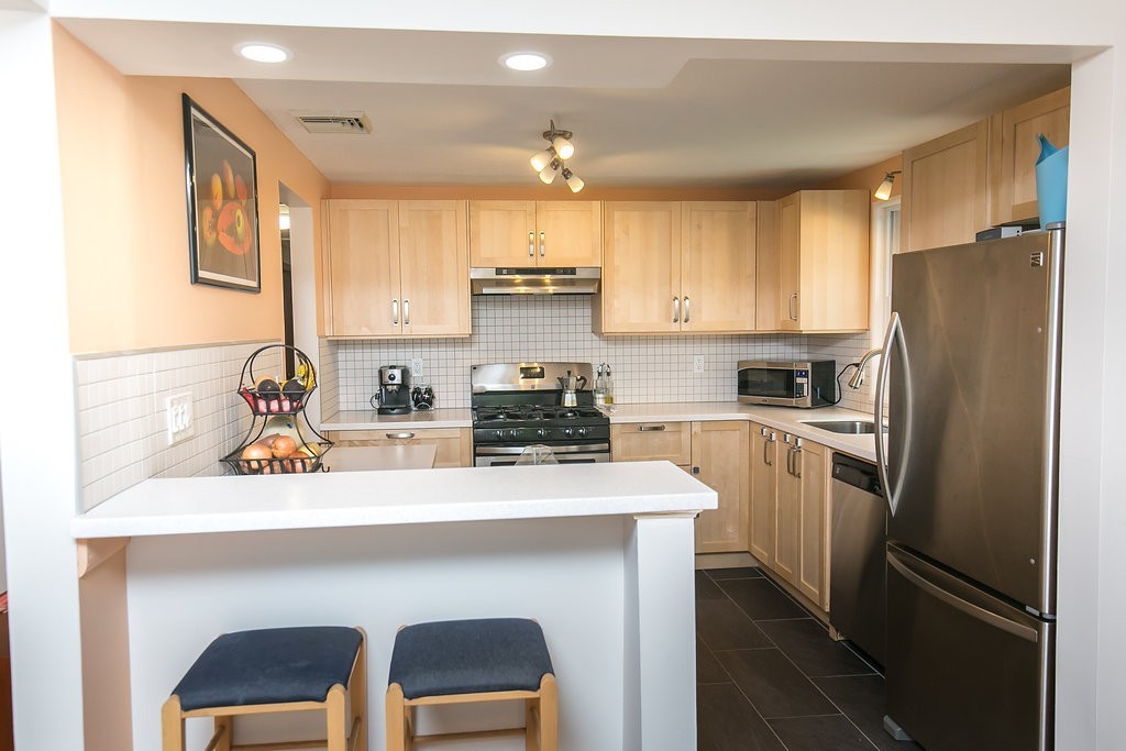 84 Bemis Road Holyoke, MA 01040 - Photo 18 of 30 a kitchen with stainless steel appliances a sink cabinets and a refrigerator