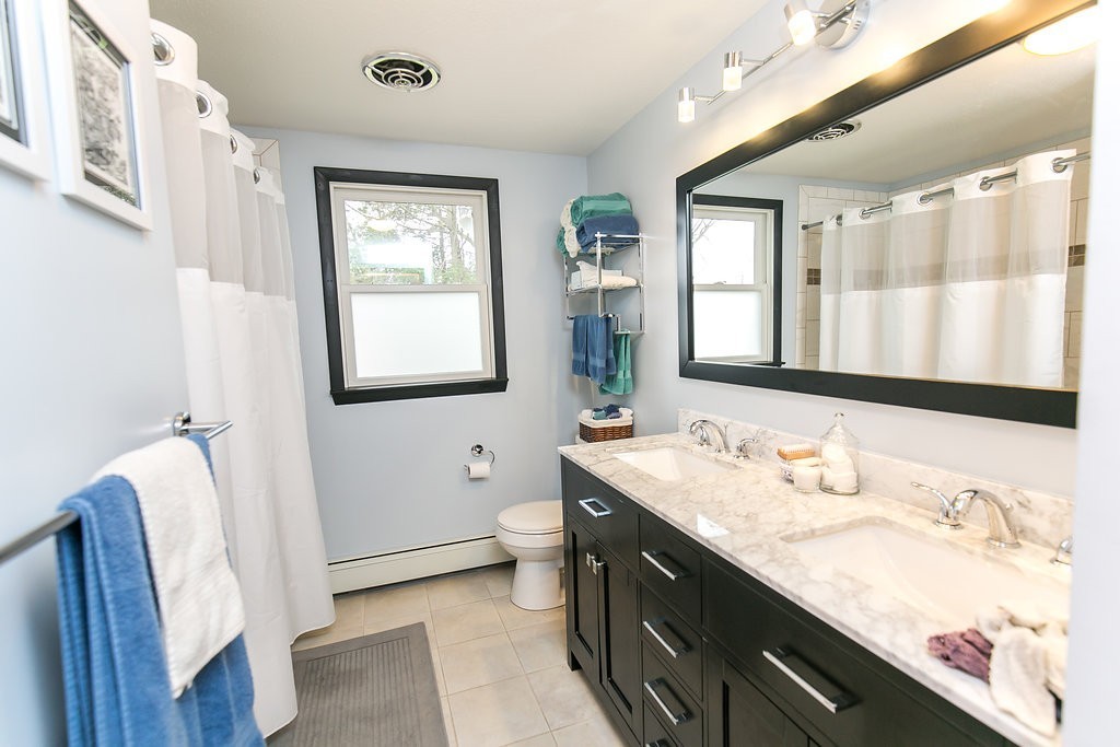 84 Bemis Road Holyoke, MA 01040 - Photo 19 of 30 a bathroom with a granite countertop sink and a large mirror
