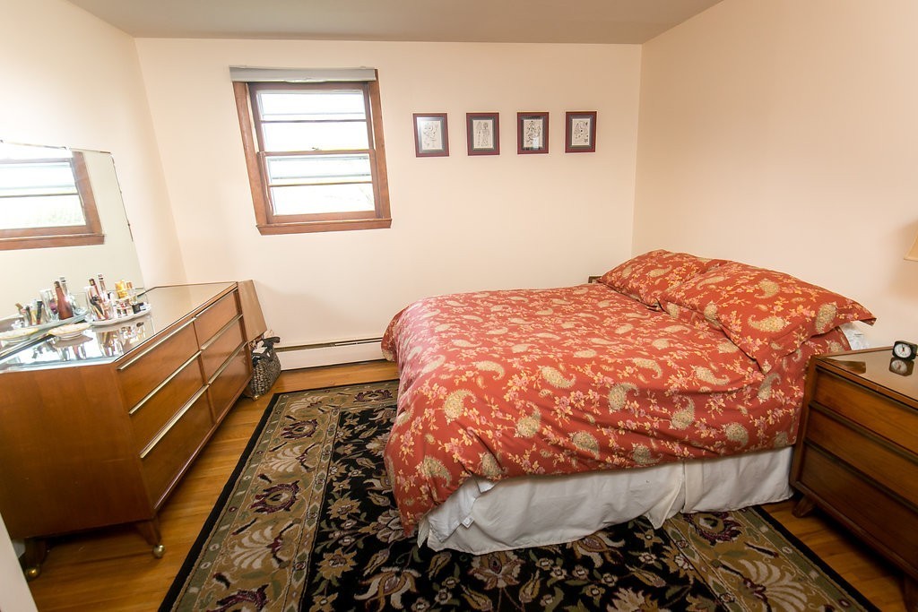 84 Bemis Road Holyoke, MA 01040 - Photo 21 of 30 a bedroom with a bed and wooden floor