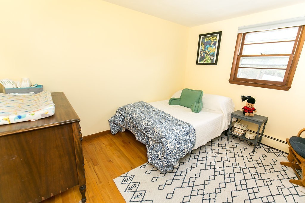 84 Bemis Road Holyoke, MA 01040 - Photo 22 of 30 a bedroom with a bed and wooden floor