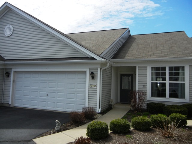 13468 Delaney Road Huntley, IL 60142 - Photo 1 of 17 a front view of a house with a yard