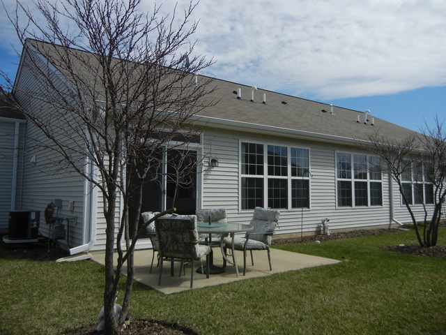 13468 Delaney Road Huntley, IL 60142 - Photo 17 of 17 a backyard of a house with table and chairs