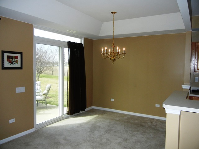 13468 Delaney Road Huntley, IL 60142 - Photo 3 of 17 a view of a livingroom with a fireplace window and a chandelier