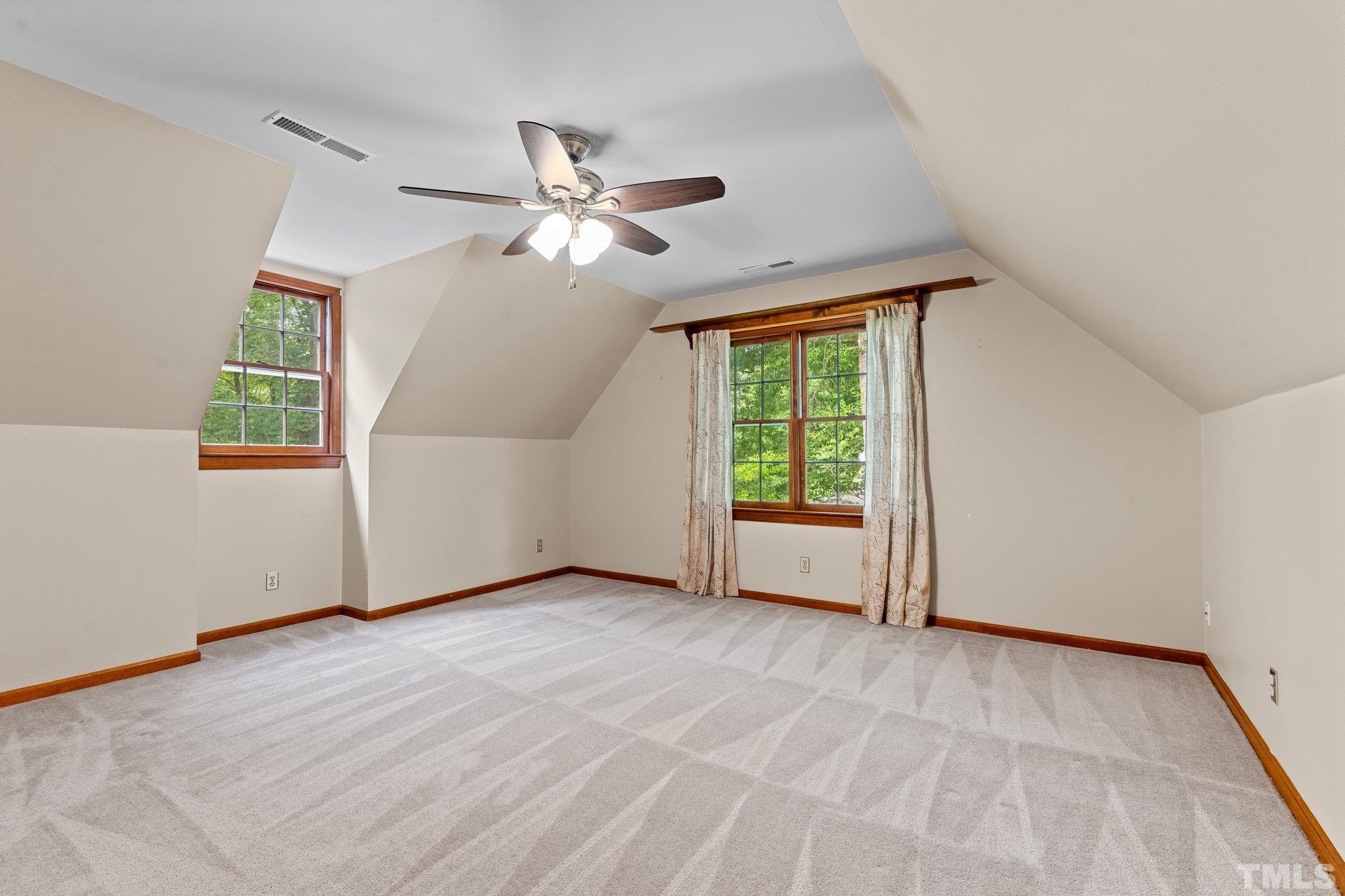 8317 Dunwood Court Raleigh, NC 27613 - Photo 30 of 50 an empty room with windows and fan