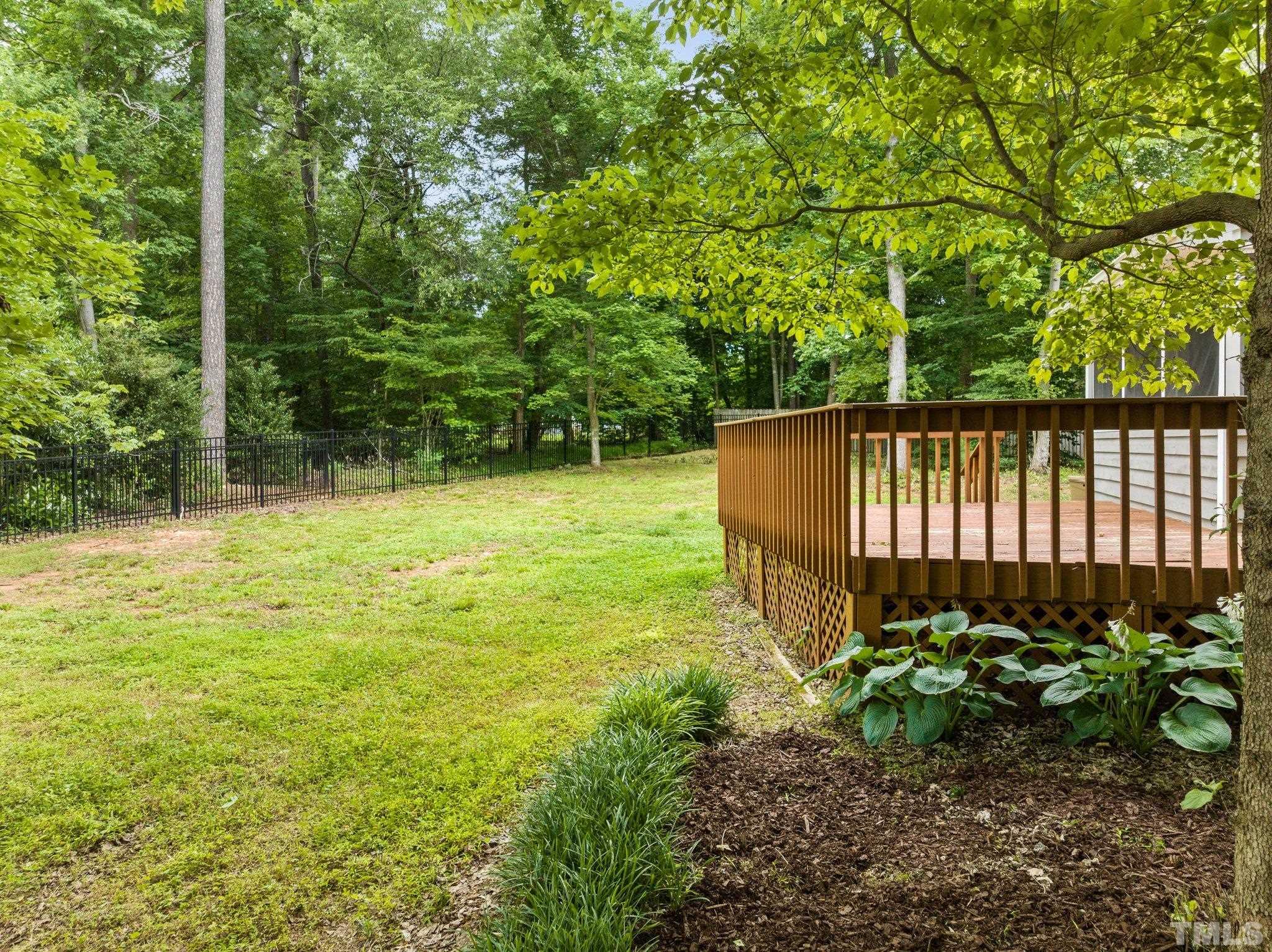 8317 Dunwood Court Raleigh, NC 27613 - Photo 45 of 50 a view of a garden with a tree