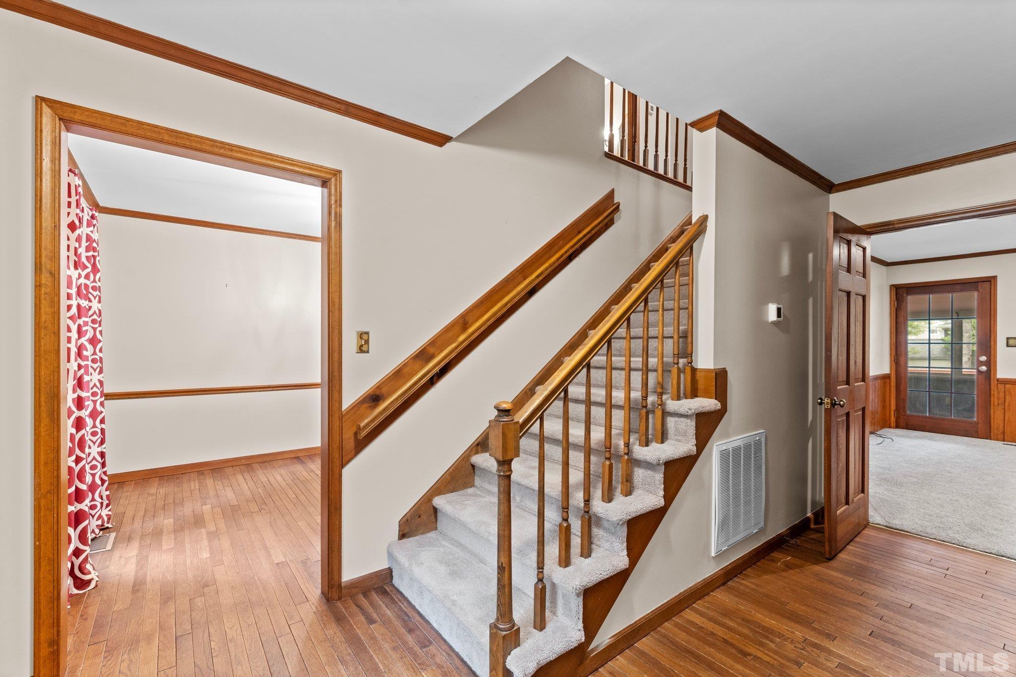 8317 Dunwood Court Raleigh, NC 27613 - Photo 5 of 50 a view of staircase with wooden floor and floors
