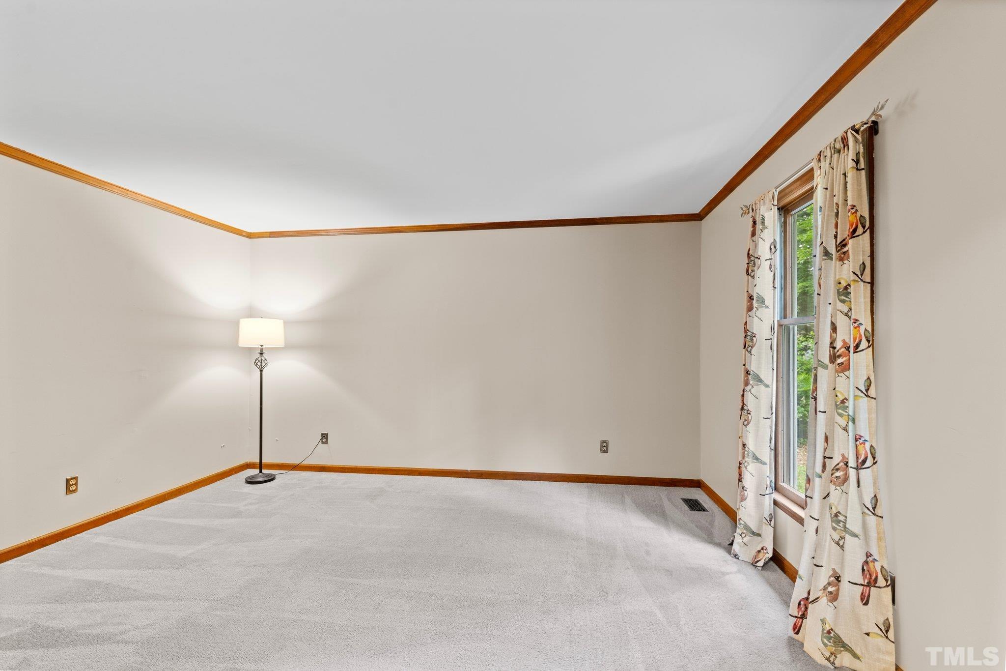 8317 Dunwood Court Raleigh, NC 27613 - Photo 7 of 50 a view of a room with wooden floor and a window
