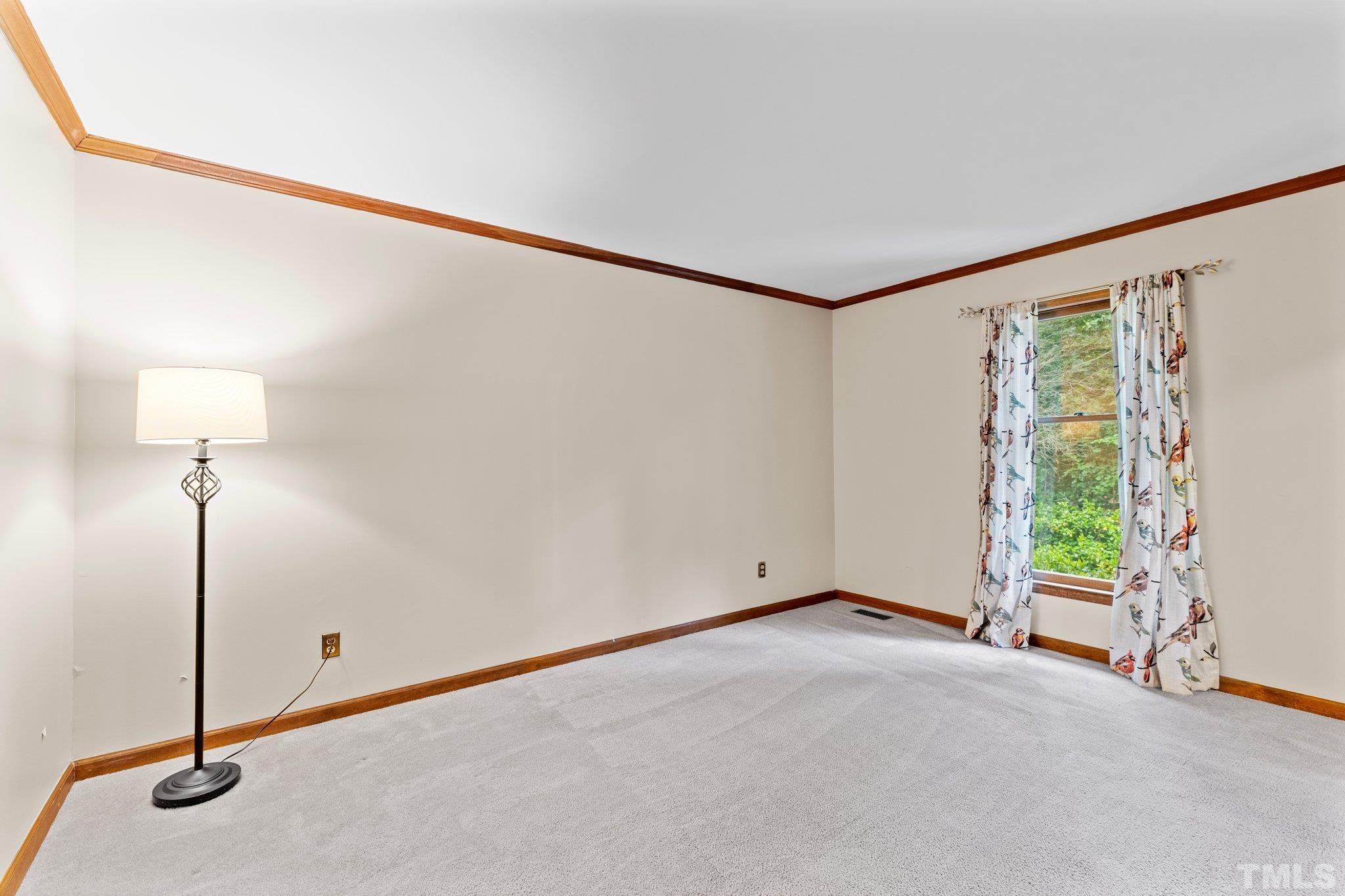 8317 Dunwood Court Raleigh, NC 27613 - Photo 8 of 50 a view of an empty room with a window