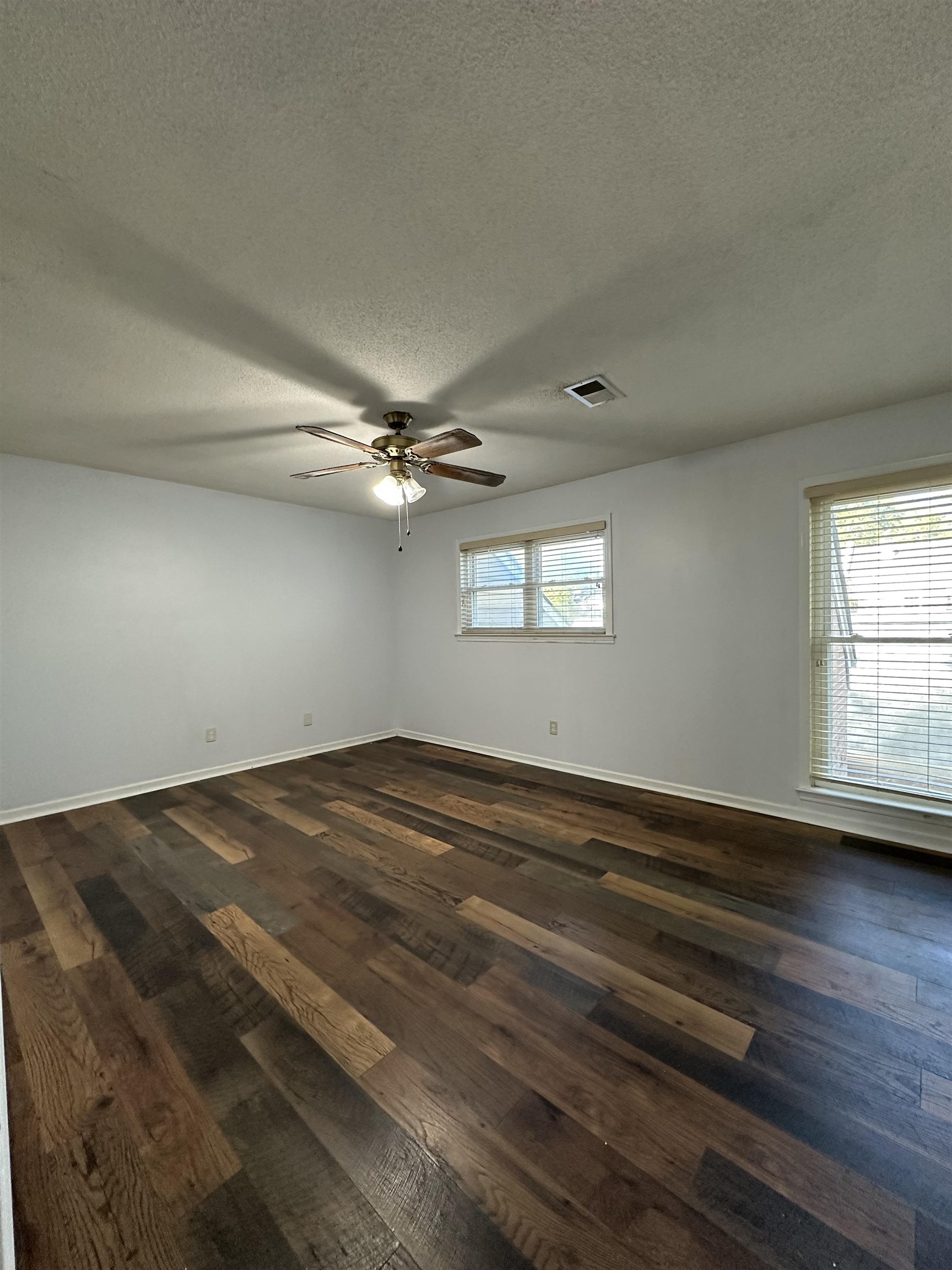 6939 Amberly Road, Unit 6939 Memphis, TN 38119 - Photo 9 of 14 Spare room with a textured ceiling, dark wood-style floors, and ceiling fan