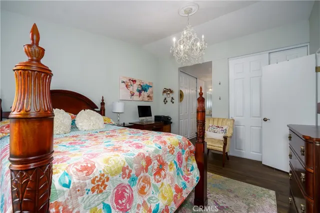 a bedroom with a bed and a chandelier