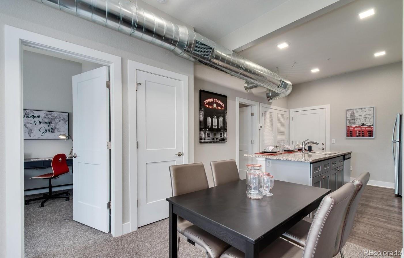 300 South Logan Street, Unit 210 Denver, CO 80209 - Photo 14 of 22 a view of a dining room with furniture and a chandelier