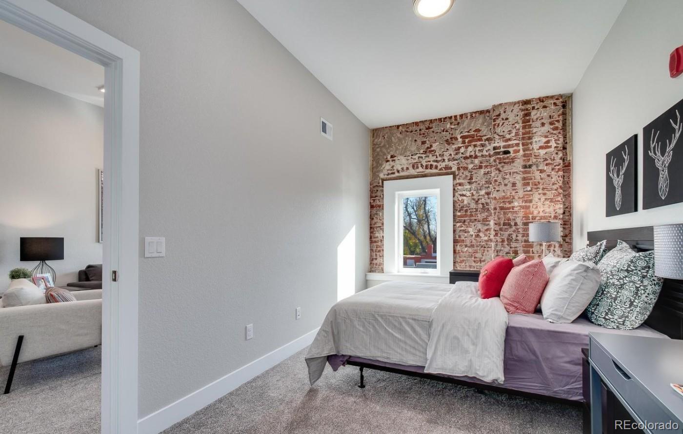 300 South Logan Street, Unit 210 Denver, CO 80209 - Photo 3 of 22 a bedroom with a bed and wooden floor