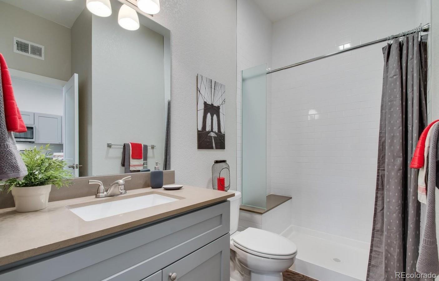 300 South Logan Street, Unit 210 Denver, CO 80209 - Photo 5 of 22 a bathroom with a sink and a mirror