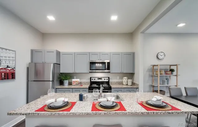 a kitchen with sink refrigerator and microwave