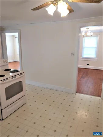 a view of wooden floor and a stove in a room