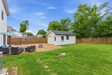 a view of backyard with outdoor seating and plants