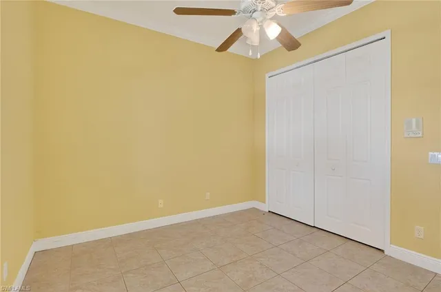 an empty room with a fan and a fan