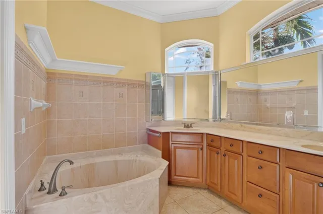 a bathroom with a tub sink and mirror