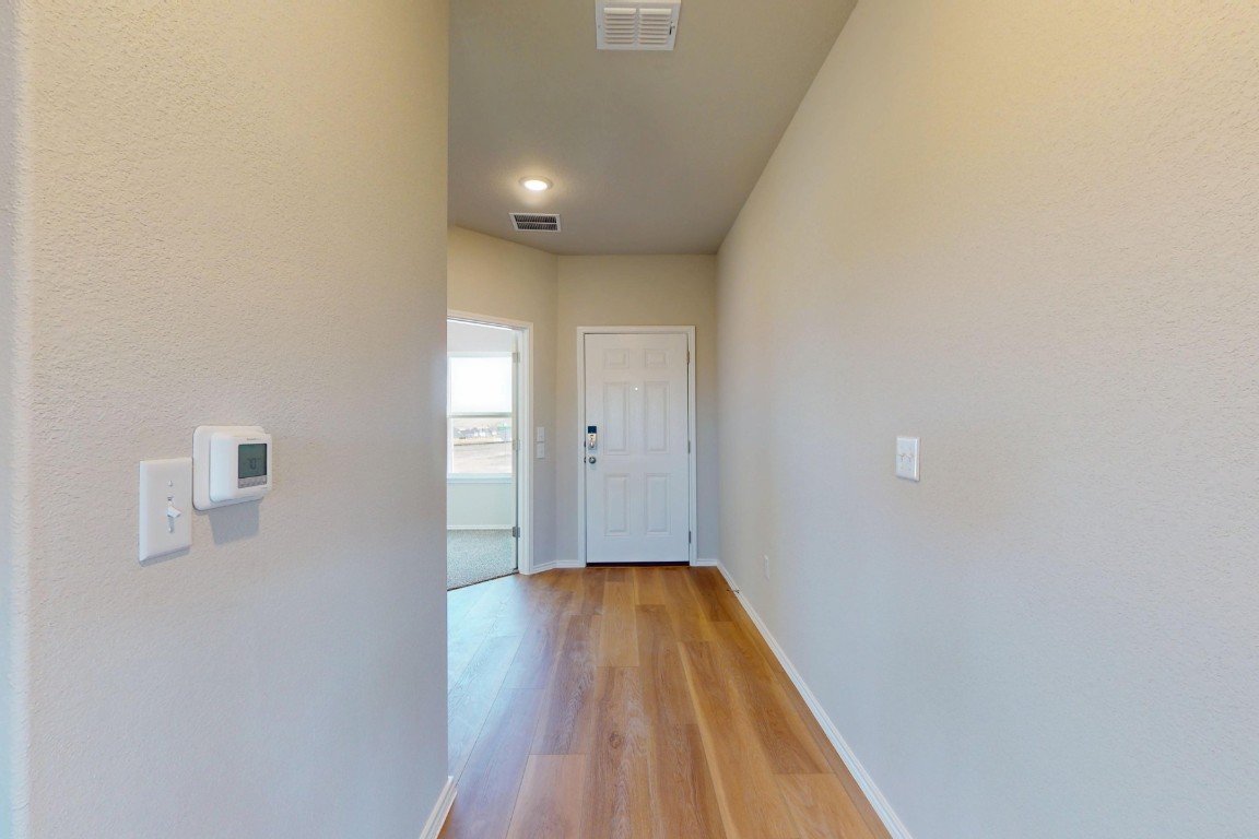 12300 Dillon Fls Drive Austin, TX 78747 - Photo 11 of 40 a view of a hallway with wooden floor