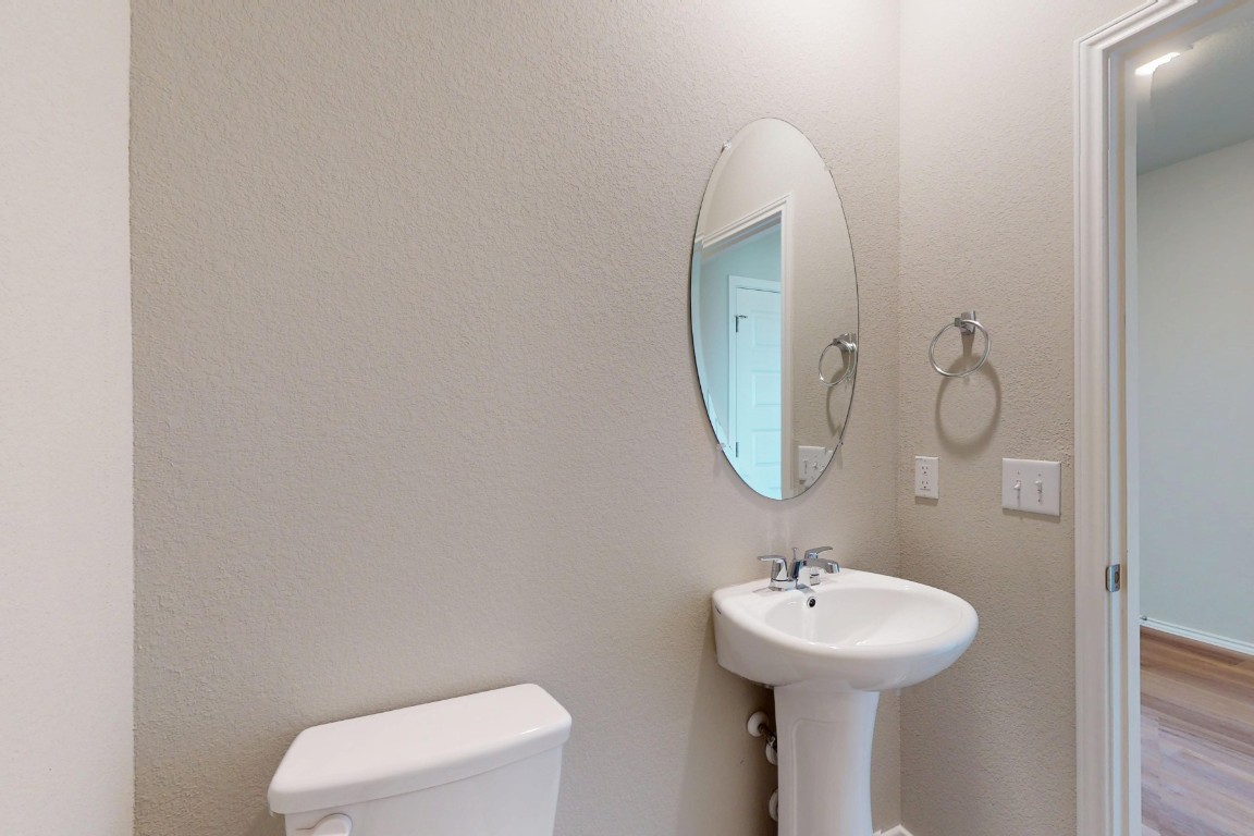 12300 Dillon Fls Drive Austin, TX 78747 - Photo 14 of 40 a bathroom with a toilet a sink and mirror
