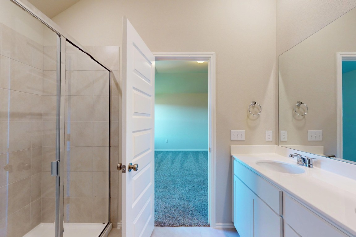 12300 Dillon Fls Drive Austin, TX 78747 - Photo 22 of 40 a bathroom with a sink and a mirror