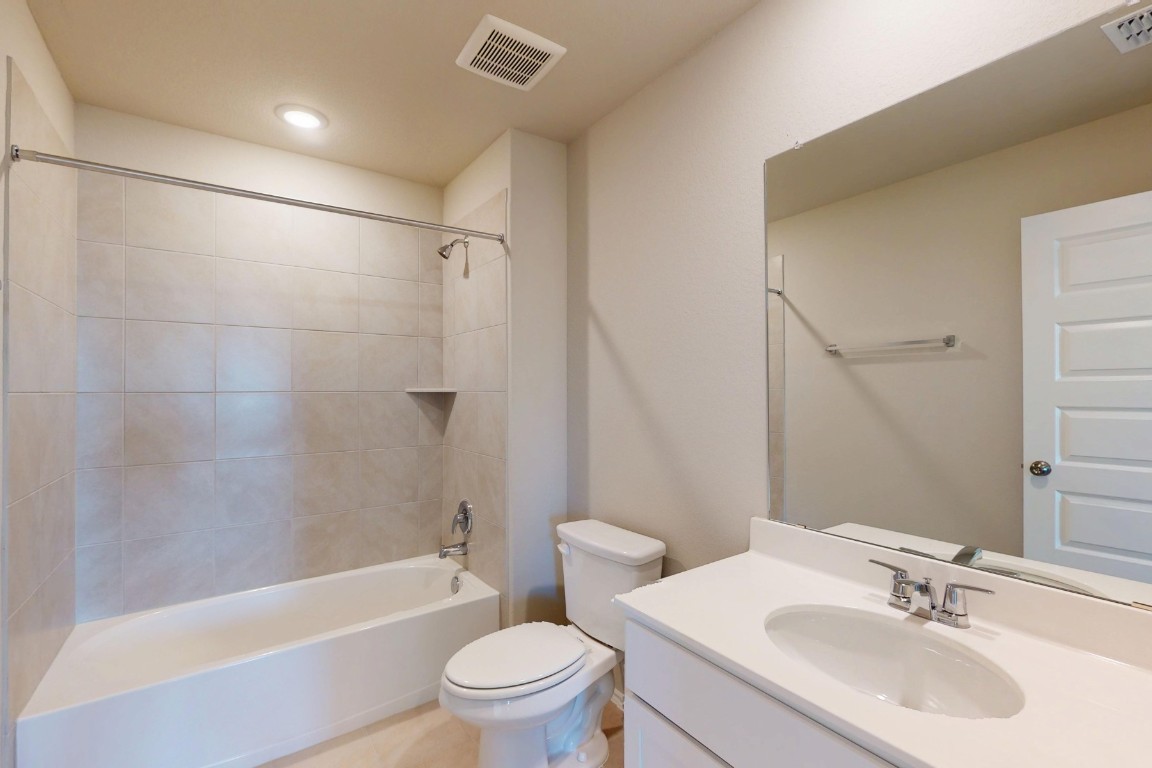 12300 Dillon Fls Drive Austin, TX 78747 - Photo 27 of 40 a bathroom with a sink toilet and shower