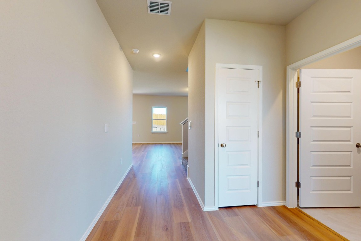 12300 Dillon Fls Drive Austin, TX 78747 - Photo 4 of 40 a view of a hallway with wooden floor