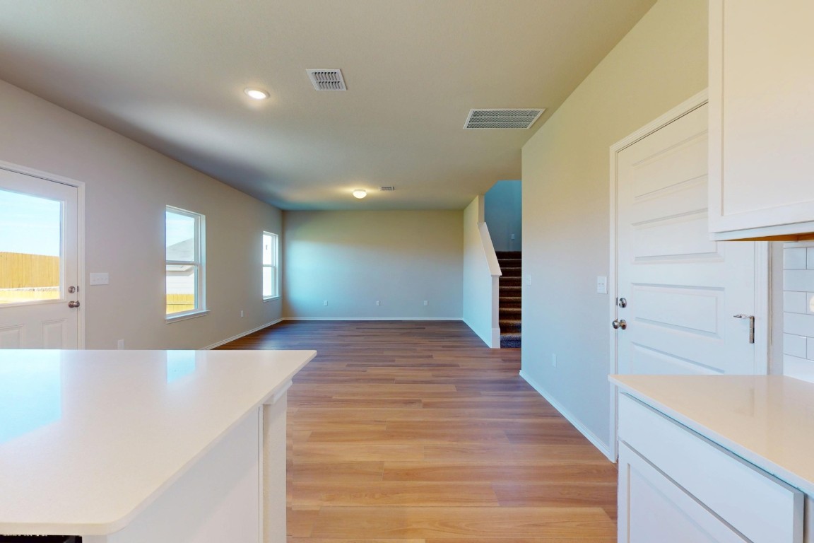 12300 Dillon Fls Drive Austin, TX 78747 - Photo 9 of 40 a view of a hallway with wooden floor and staircase