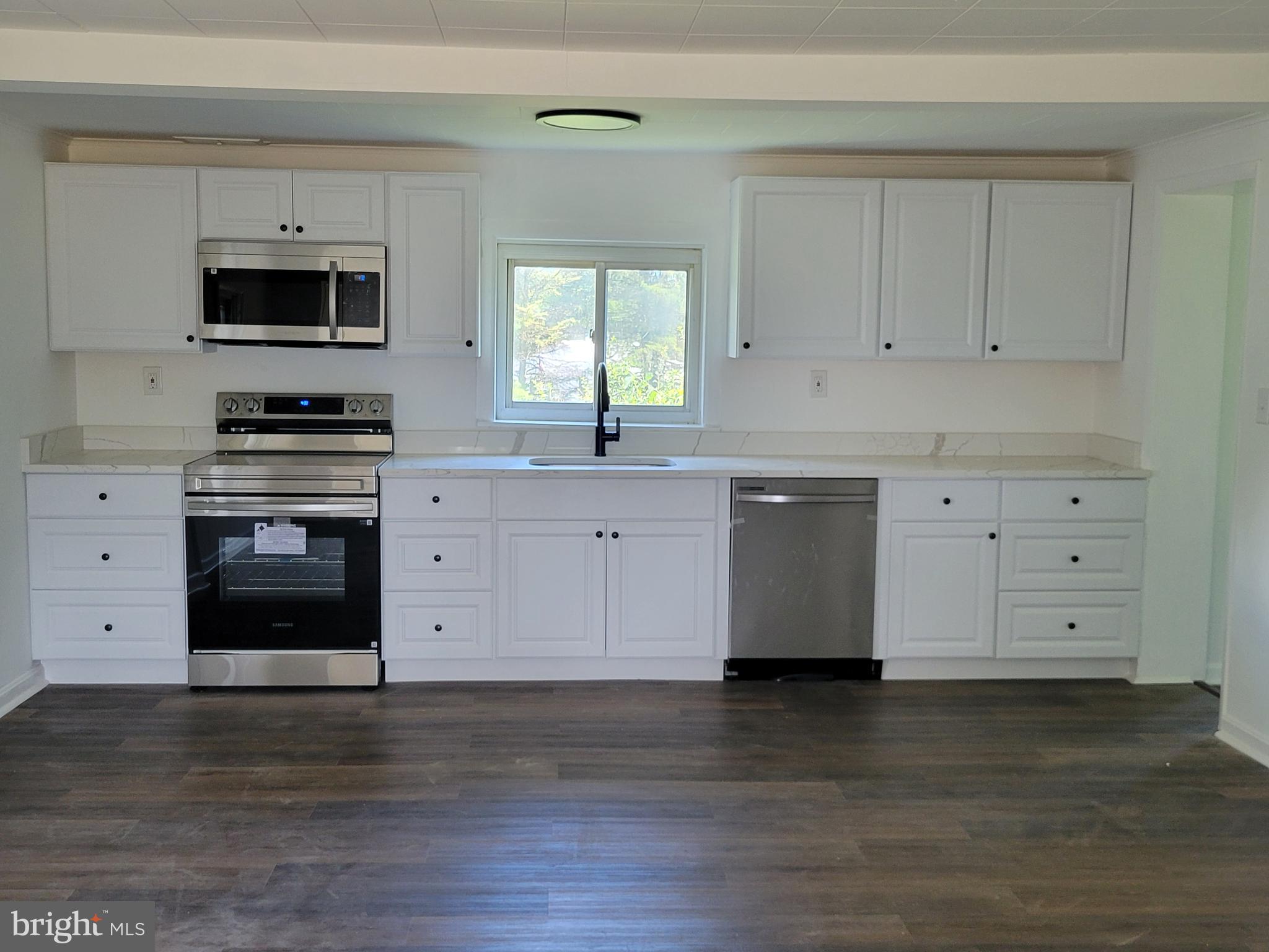 315 Emmert Road Hagerstown, MD 21740 - Photo 3 of 11 a kitchen with stainless steel appliances granite countertop a stove a sink and a microwave