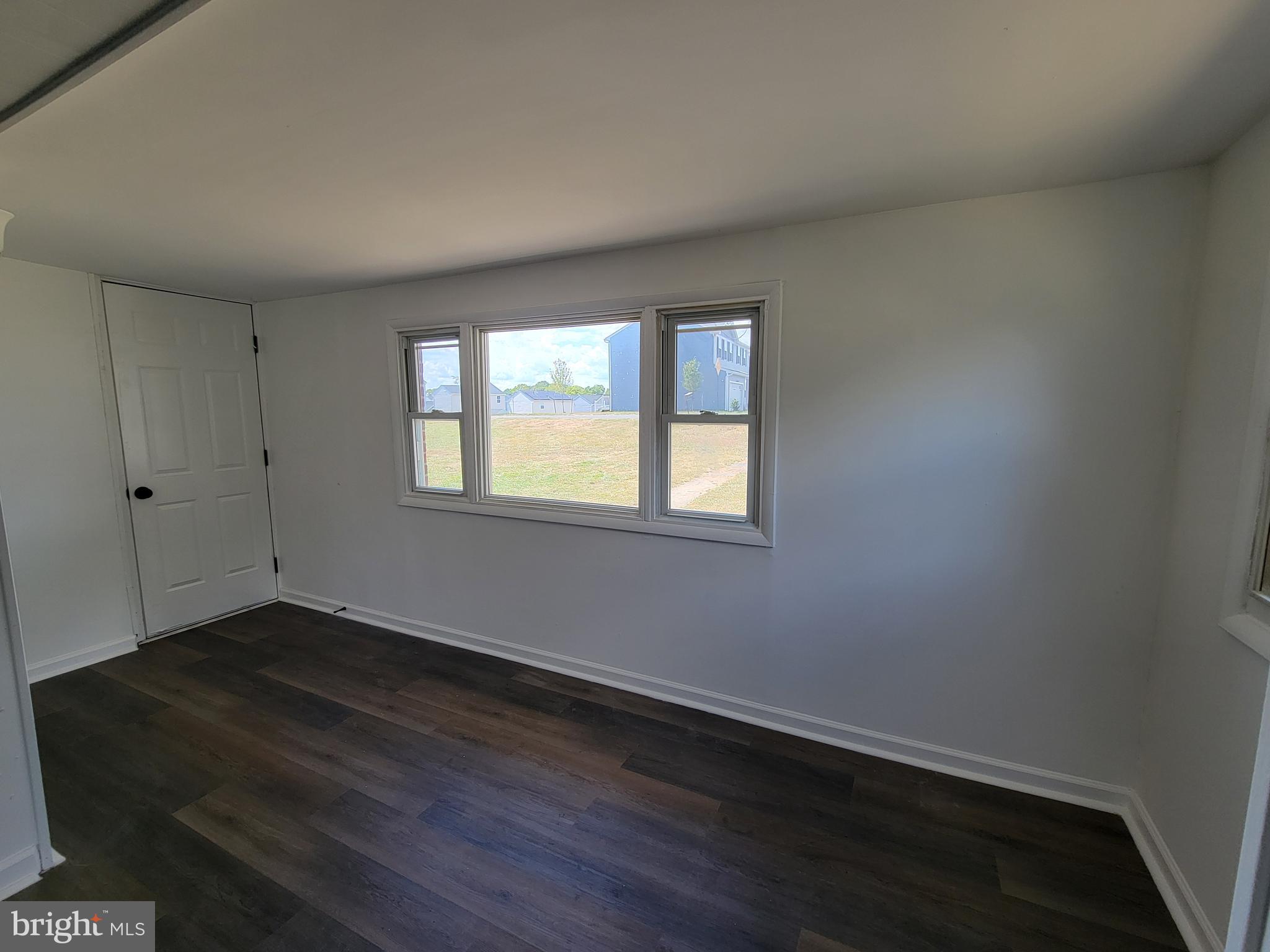 315 Emmert Road Hagerstown, MD 21740 - Photo 5 of 11 a view of an empty room with wooden floor and a window