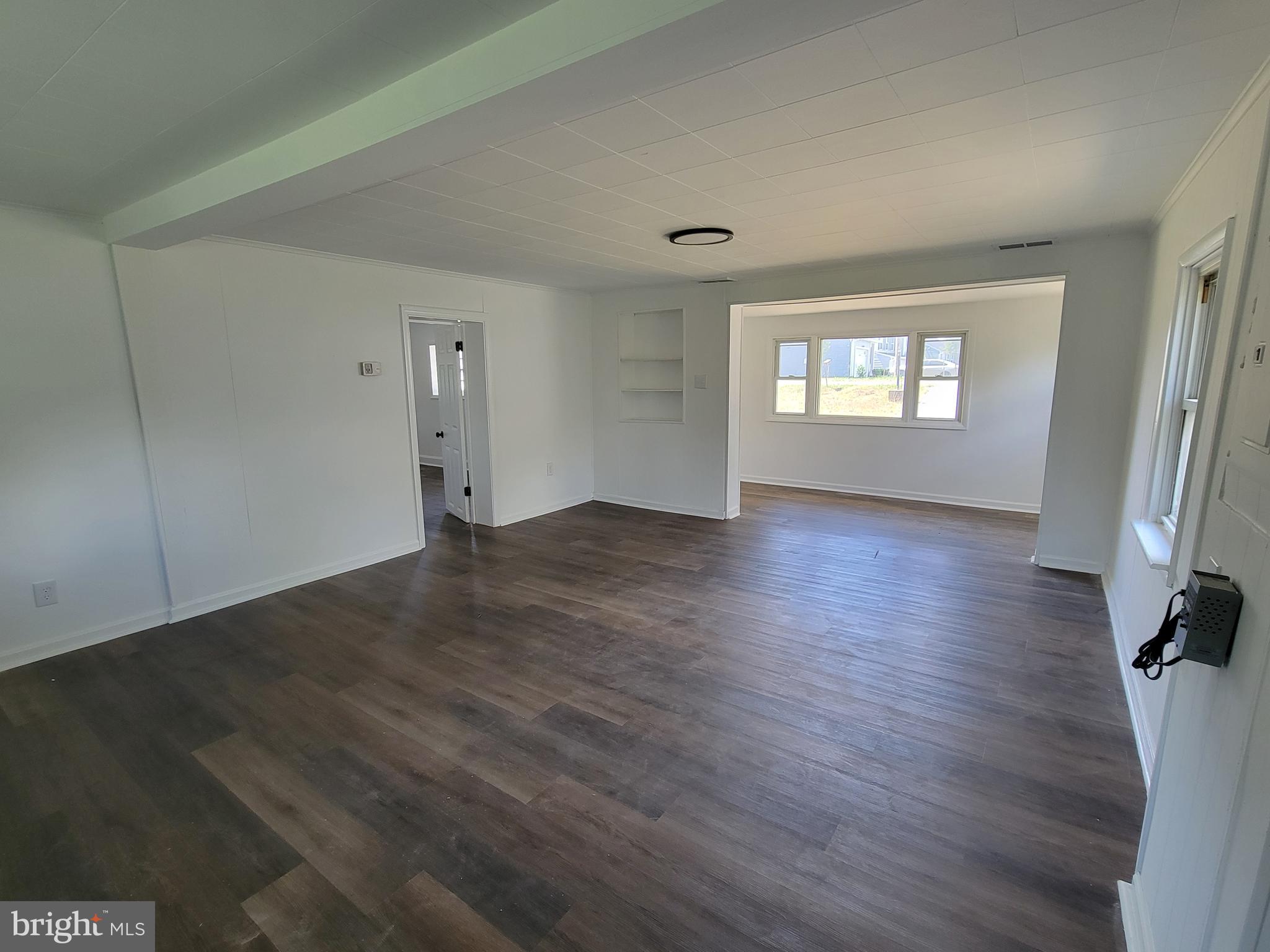 315 Emmert Road Hagerstown, MD 21740 - Photo 6 of 11 an empty room with wooden floor and windows