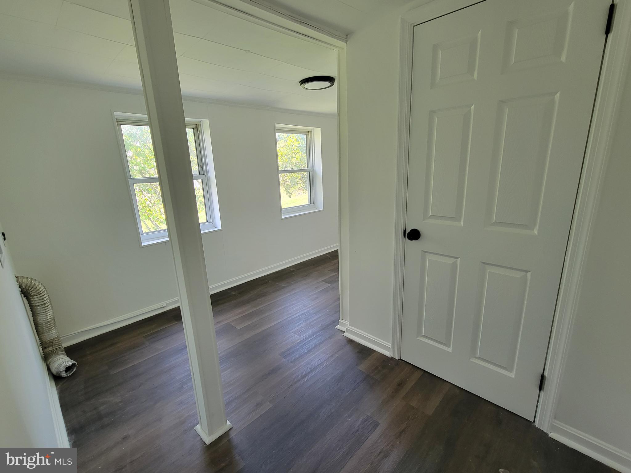 315 Emmert Road Hagerstown, MD 21740 - Photo 8 of 11 an empty room with wooden floor and windows